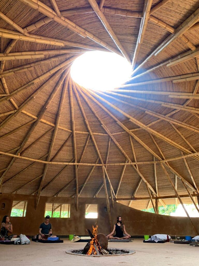 Inside a thatched maloka, the fire in the centre